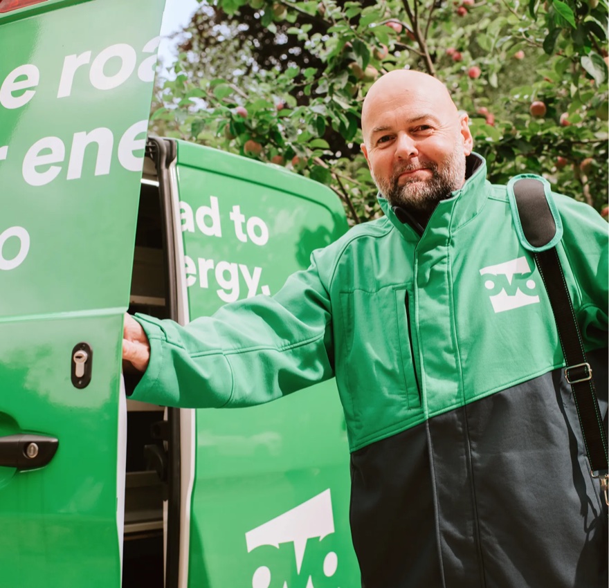 An OVO Energy Expert standing beside a branded van.