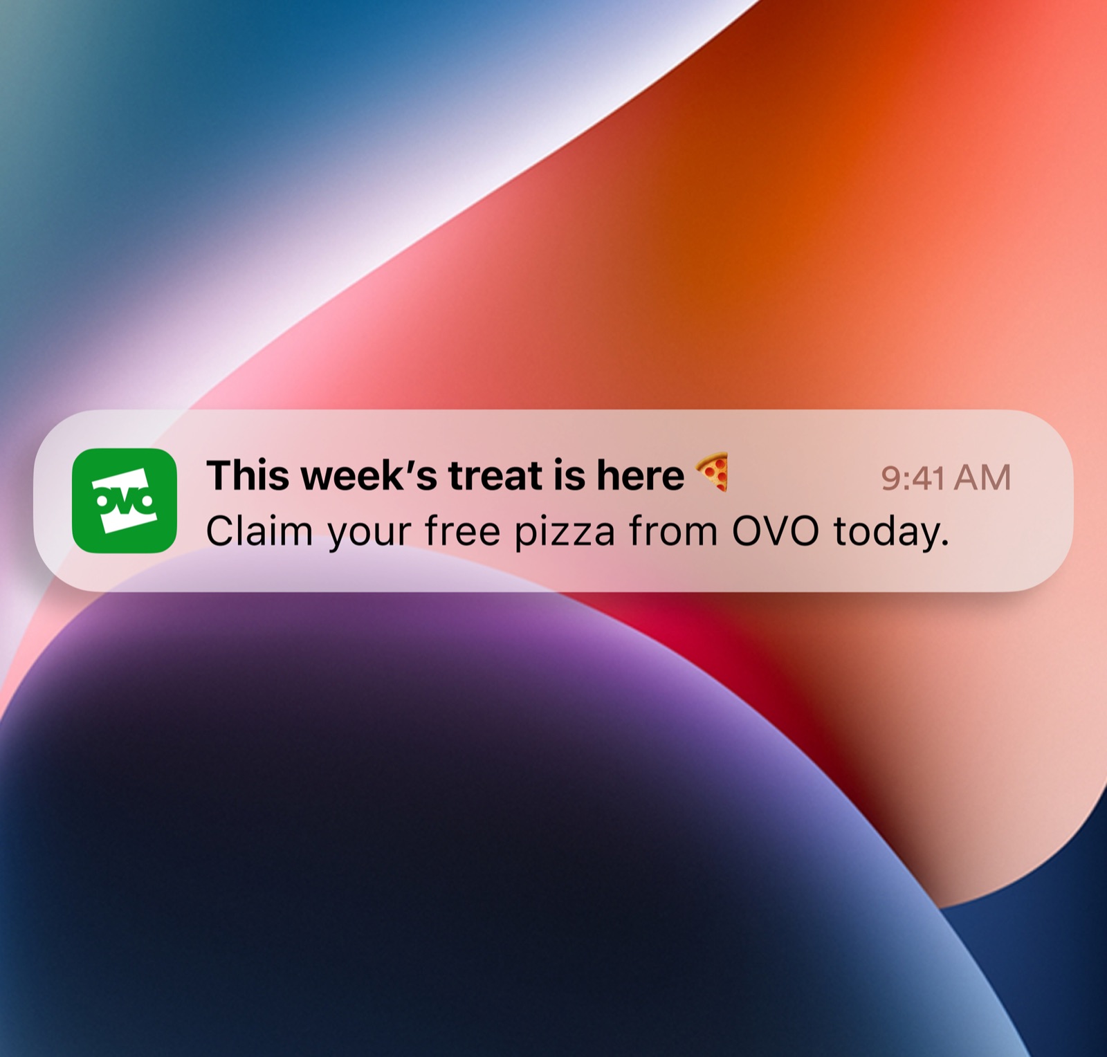 A lock screen notification: 'This week's treat is here — claim your free pizza from OVO today.'